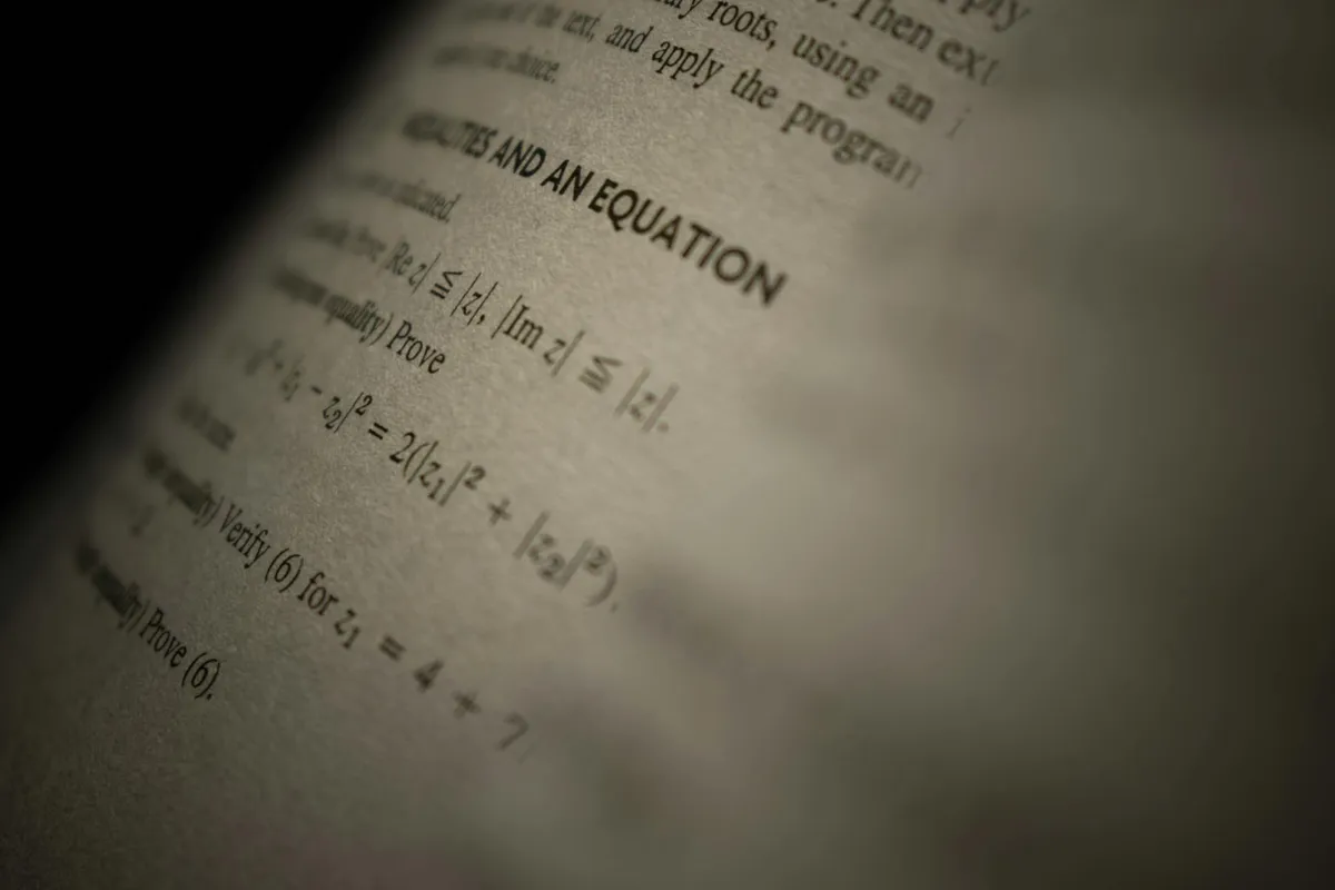 A worn library book of mathematical notation, open on a desk