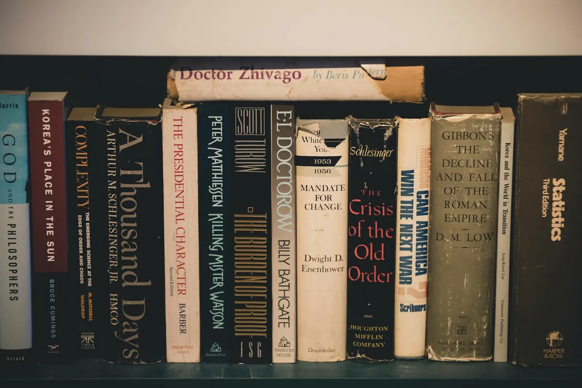 A row of old hardcover mathematics books on a library shelf